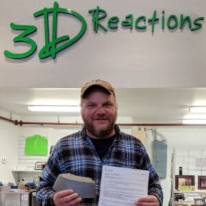 President of 3DReactions John Majersky holding a 3D print submission for a project