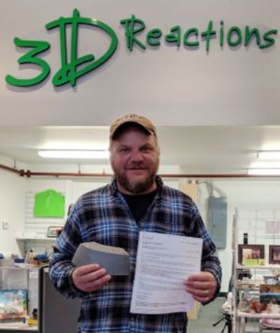 President of 3DReactions John Majersky holding a 3D print submission for a project