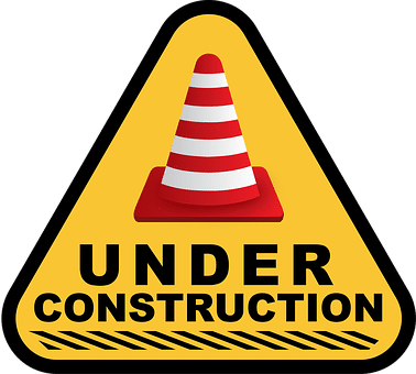 Yellow triangular sign featuring a traffic cone and the words 'UNDER CONSTRUCTION'